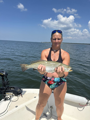 Woman on a boat holding a fish